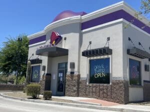 A building with purple trim and a large window.